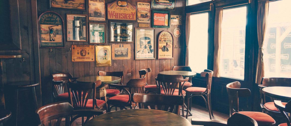 empty chairs and tables inside a traditional pub