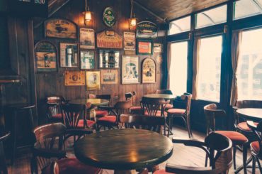 empty chairs and tables inside a traditional pub