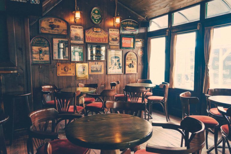 empty chairs and tables inside a traditional pub
