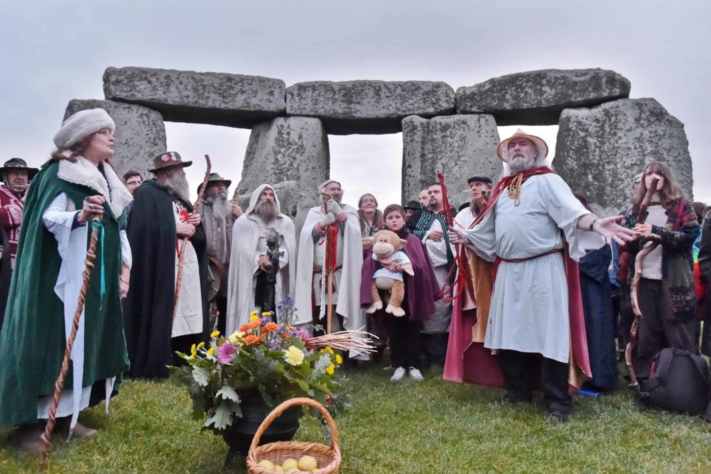 druids gather in the inner circle for the equinox at stonehenge