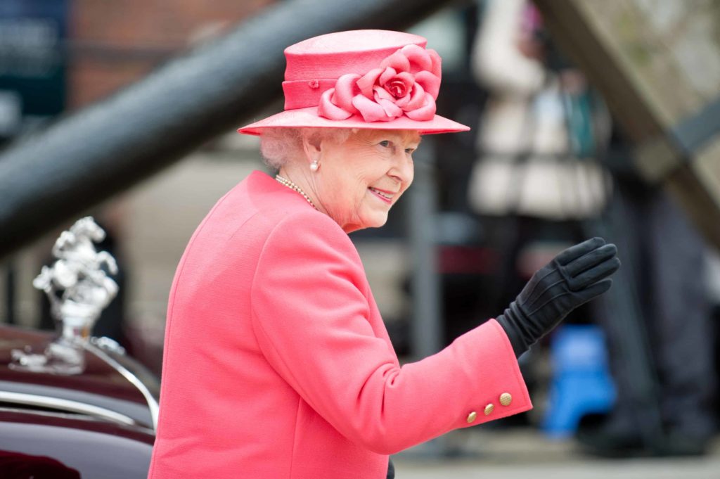 hrh queen elizabeth wearing pink coat and matching hat