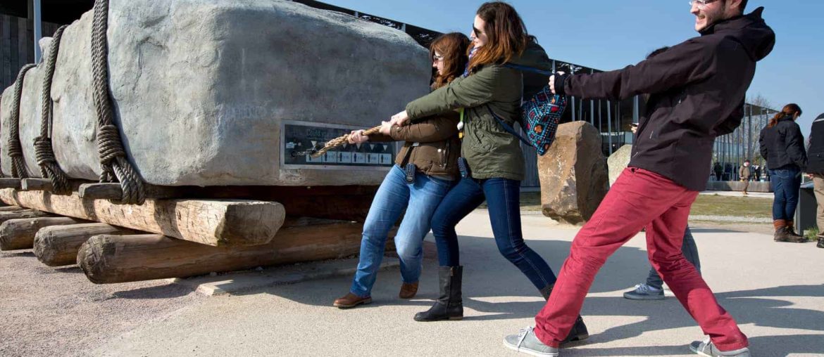 group of people attempting to pull a sarsen stone at stonehenge