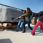 group of people attempting to pull a sarsen stone at stonehenge