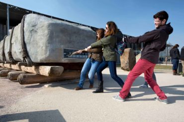 group of people attempting to pull a sarsen stone at stonehenge