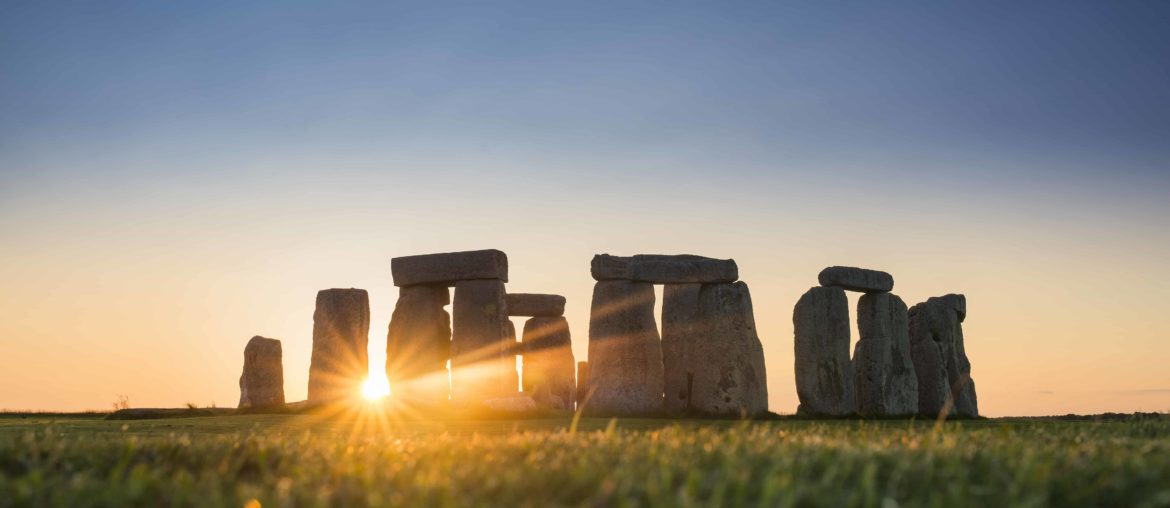 view of stonehenge at sunset from the mound