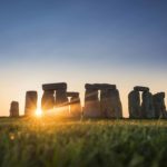 view of stonehenge at sunset from the mound