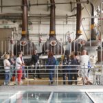 tour group next to copper stills at the beefeater gin distillery tour in london
