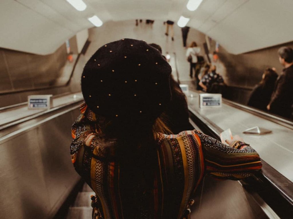 woman standing on right of escalator in london