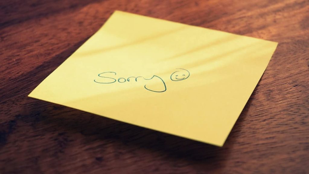 hand written sorry note on desk