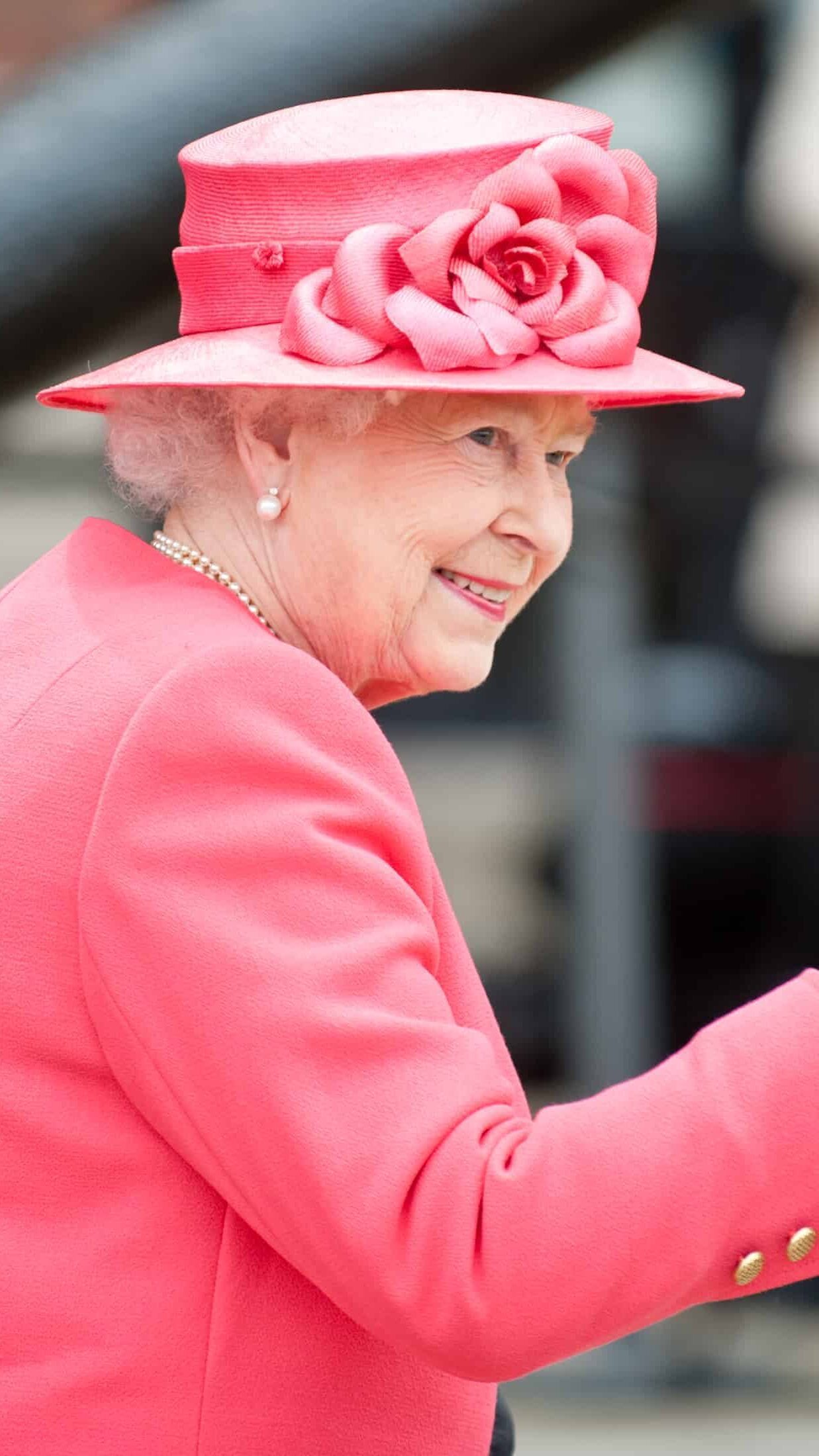 hrh queen elizabeth wearing pink coat and matching hat